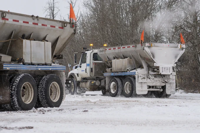 Two City snow plows clear a road in Edmonton.