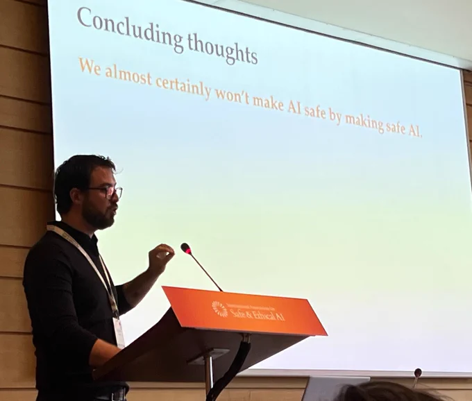 Stephen Casper (MIT) on stage speaking