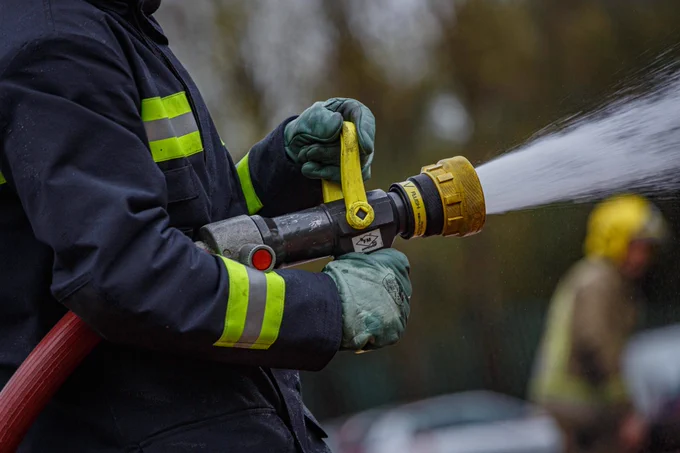 A firefighter squirting water from a hose