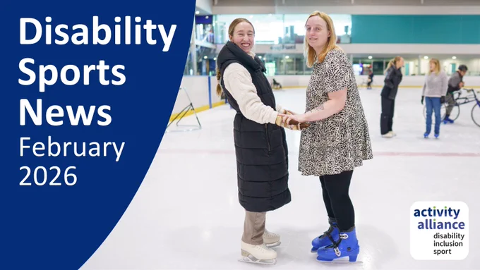 Disability Sports News February 2026. Two women stand together on an ice rink holding hands and smiling at the camera. They are taking part in an inclusive ice skating session. 