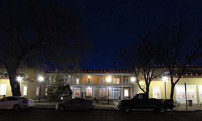A photo of the front of the Main Library building lit up at night