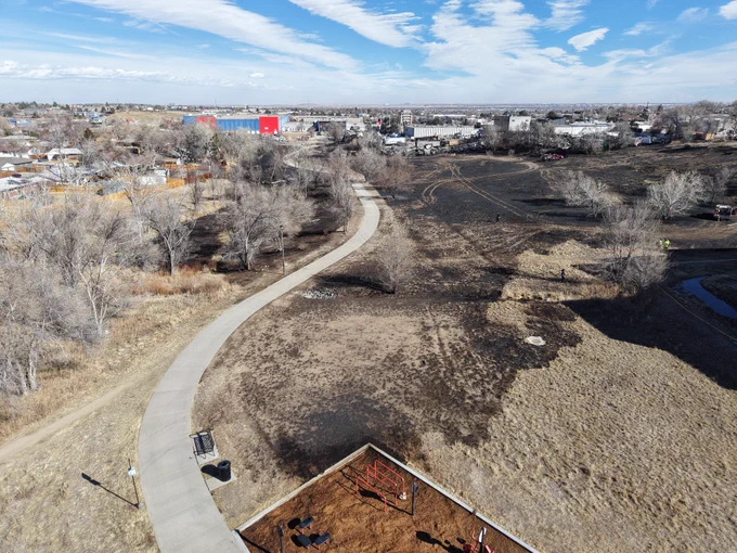 Aerial view of fire burn showing nearby homes.