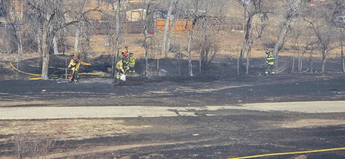 Firefighters working hot spots at vegetation fire.