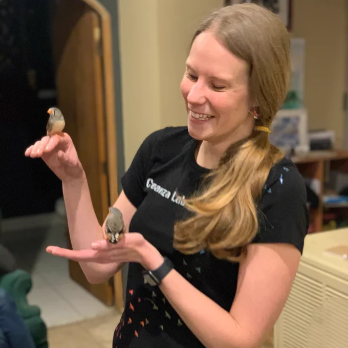 Kate Snyder with a huge smile while holding two birds