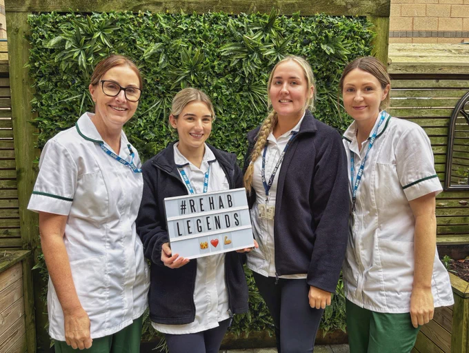 Rehab Legends posing in the therapy garden with the #RehabLegend lightbox
