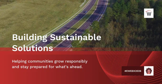 Aerial view of a multi-lane divided highway cutting through grassy and wooded landscape with overlaid text reading “Building Sustainable Solutions” and “Helping communities grow responsibly and stay prepared for what’s ahead.” #EWEEK2026 with Waggoner logo.