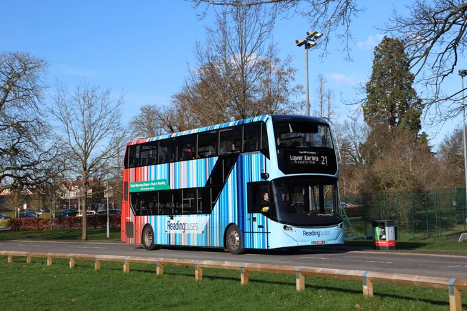 Reading Buses 3 (RG03ZEB) is a blue and red Climate Stripes liveried Alexander Dennis Enviro400EV and is pictured on Whiteknights Campus as it headed to Lower Earley on route 21. The climate stripes represent global warming in the last 250 years, created by Professor Ed Hawkins at the University of Reading. 