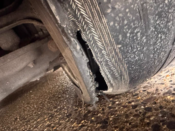 Extremely bold tyre with a large rip to the inside 