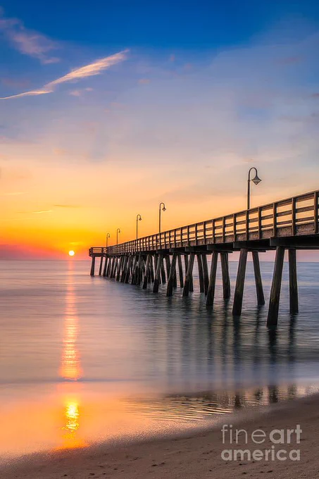 Last Light on the Gulf Shore by Shelia Hunt is a Fine Art piece showcasing a sunset pier near Clearwater Beach with warm, tranquil light.