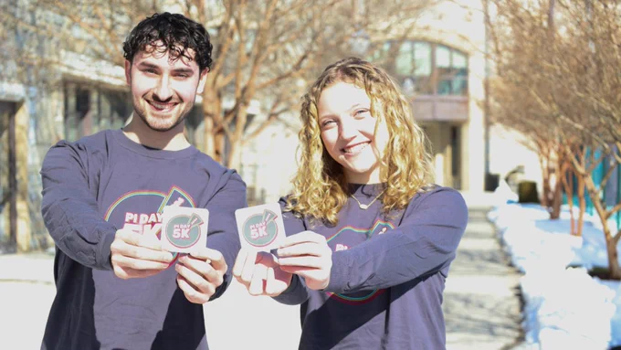 photo of two students wearing Pi Day swag outside of McComas Hall