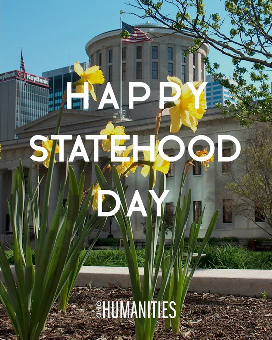 The words “Happy Statehood Day” and the Ohio Humanities logo, both in white, overlaid on a photo of yellow daffodils blooming in Spring on the West side of Capitol Square in Columbus, Ohio. The Statehouse cupola appears in the background.