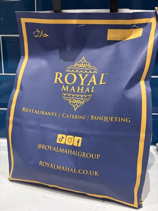 A dark blue takeaway bag from Royal Mahal the best local curry house.