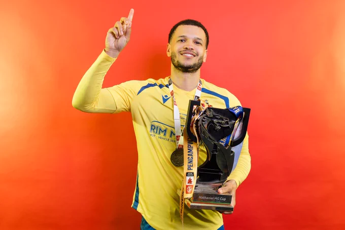Theo Wharton celebrates Barry Town United winning the Nathaniel MG Cup.
