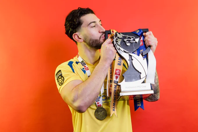 Ollie Hulbert celebrates Barry Town United winning the Nathaniel MG Cup.