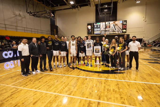 The entire Cal State LA Mens Basketball surrounds the two Seniors on the team. 
