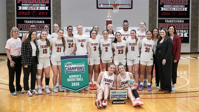basketball team posing on the court