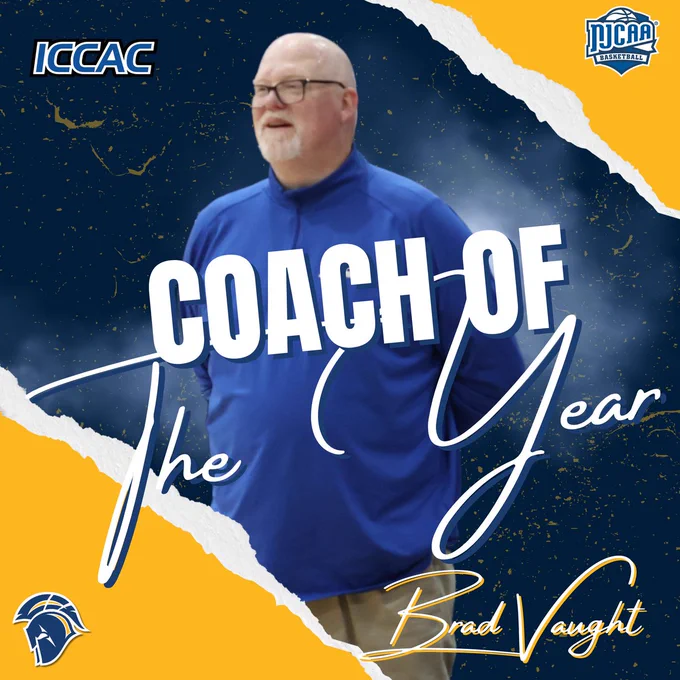 ICCAC “Coach of the Year” graphic featuring Brad Vaught in a sideline photo on a navy-and-gold torn-paper background. Large text reads “COACH OF THE YEAR,” with “Brad Vaught” in script, plus ICCAC, NJCAA Basketball, and NIACC Trojans logos.