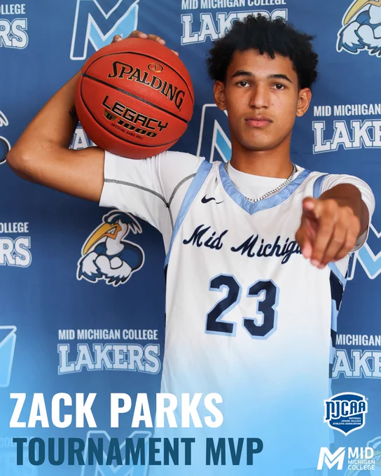 Zack Parks from the Men's Laker Basketball Team poses with a basketball in front of a backdrop.