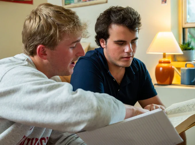 students looking at a book