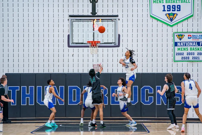 Dallas College North Lake men’s basketball’s Romiel Carter leaps while swatting at a shot from Dallas College Brookhaven’s Anshuman Deora in the Blazers’ 101-79 NJCAA Division III South Central District championship win.