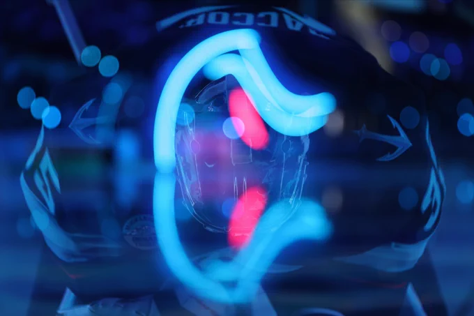 Double exposure look at Joey Daccord bending forwards while in the tunnel in a Kraken uniform.