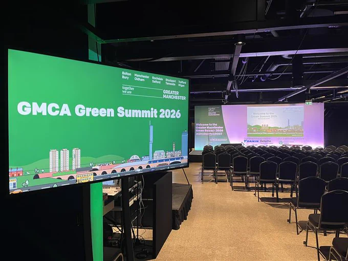 TV screen saying GMCA Green Summit 2026 with a large seating and screen in the background.