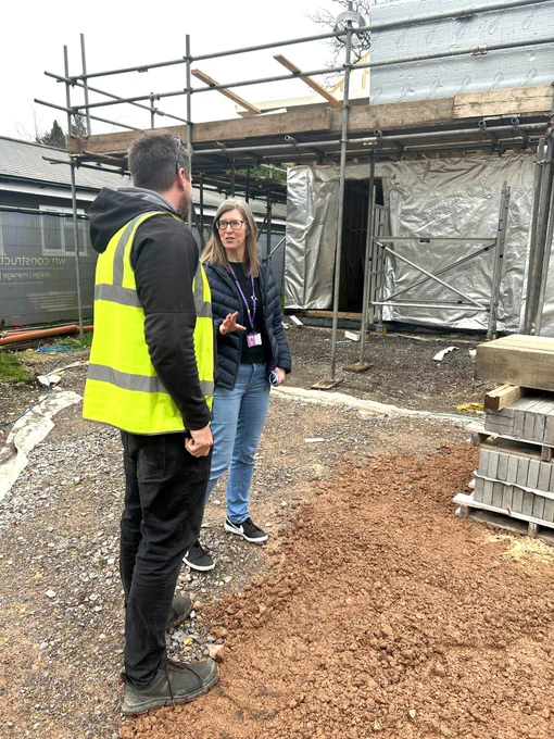 Hannah and WIll looking at the building partially built on a building site