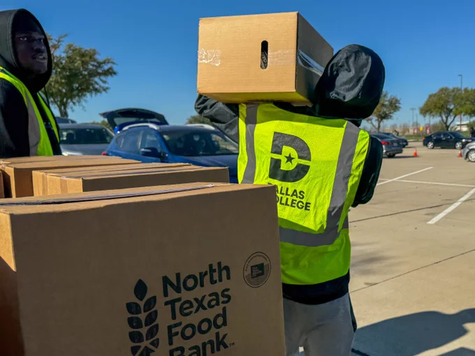 Volunteer with a box on his shoulder.