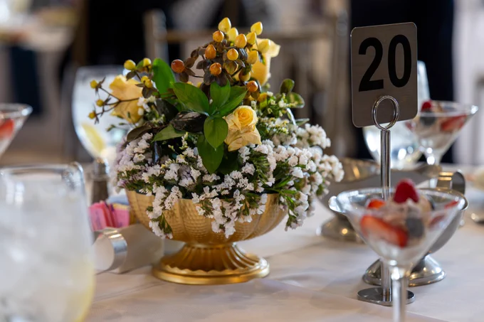 A floral arrangement sits on a table. 