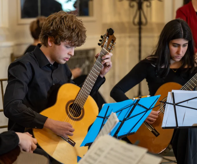 Students play the guitars.