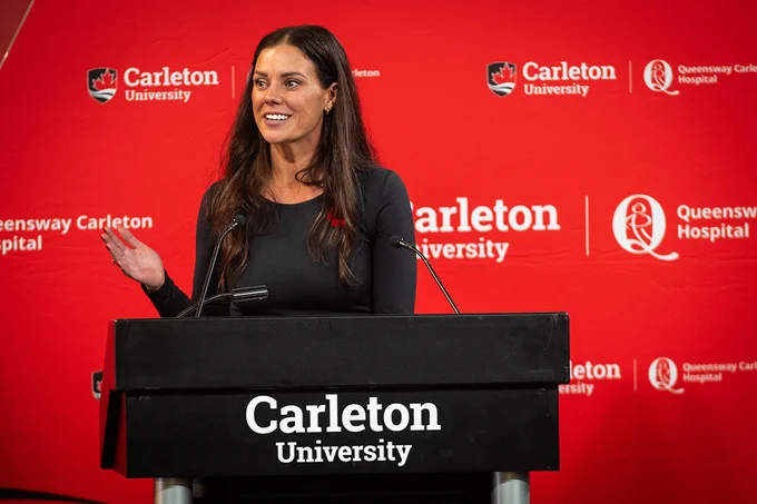 Carleton University School of Nursing director Danielle Manley speaks at a podium during the nursing program launch event. 