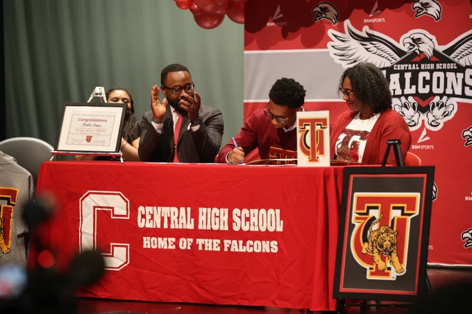 Parker signing his commitment papers