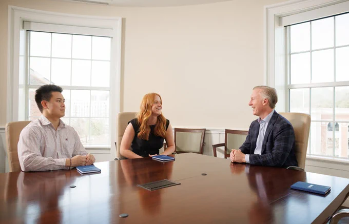 Chairman and CEO of Landmark Properties, Wes Rogers, talks with Terry College Real Estate students Sydney Kennedy and Sean Nguyen, who are both members of the UGA Real Estate Society.