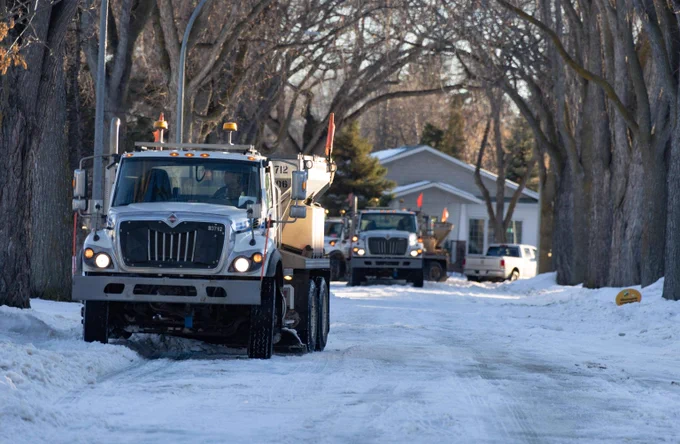 A team of City of Edmonton snow plows clears a residential road in Edmonton. 