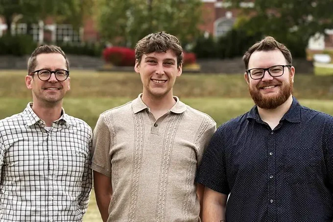 Barry Blight, Mason Lawrence and Robbie Horne standing outdoors. 
