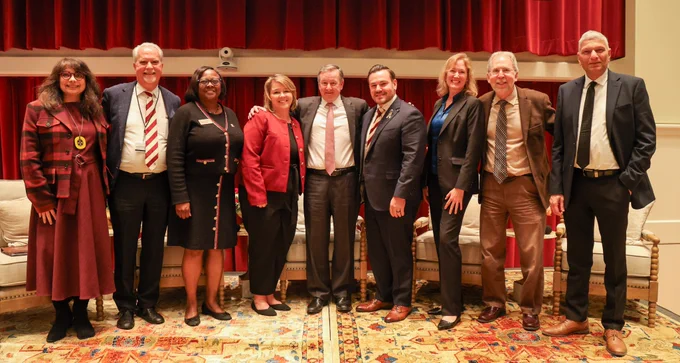 Panelists and event speakers stand together for a group photo on stage at the Florida State University College of Medicine Rare Disease Day 2026 event.