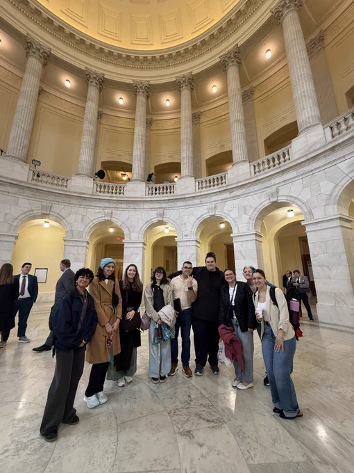 Group of students stand in Cannon Building rotunda