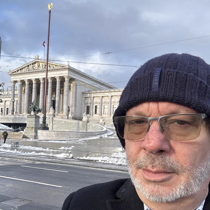Andy in front of the Austrian Parliament Building in Vienna 