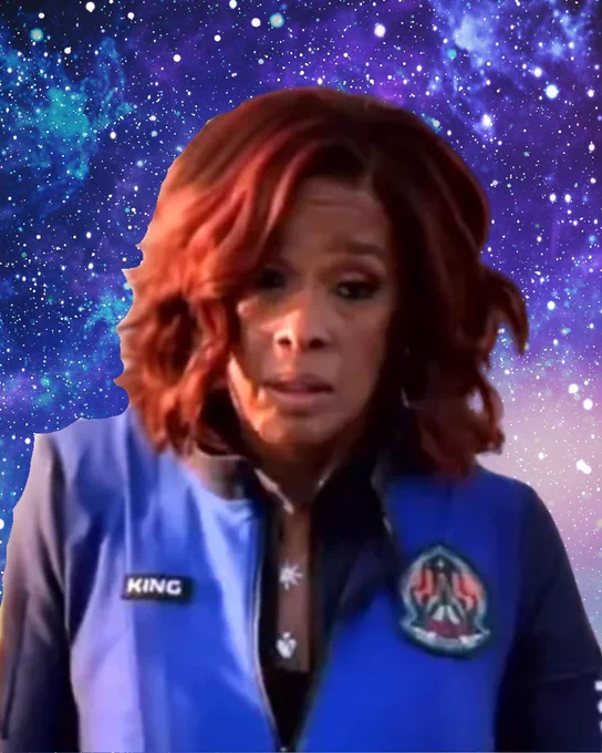 An image of Gayle King after her spaceflight, superimposed over a background of stars and purple and blue space dust. Gayle looks miserable and is wearing a blue spaceflight suit that says "King" on her right side.
