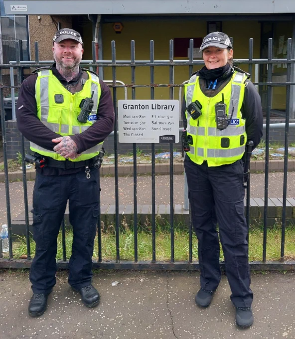 Two Police officers in full uniform standing in front of Granton library