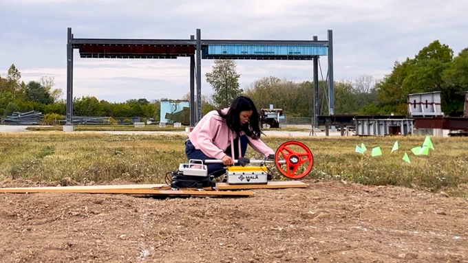 Yuxi Zhang, a Purdue University doctoral candidate in civil engineering, conducts a preliminary field test of a ground-penetrating radar system on an uneven surface. Zhang and Purdue researcher Hubo Cai have developed a patent-pending method to decrease hazardous strikes to underground utility pipes.