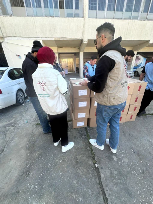 Staff moving boxes of supplies. 