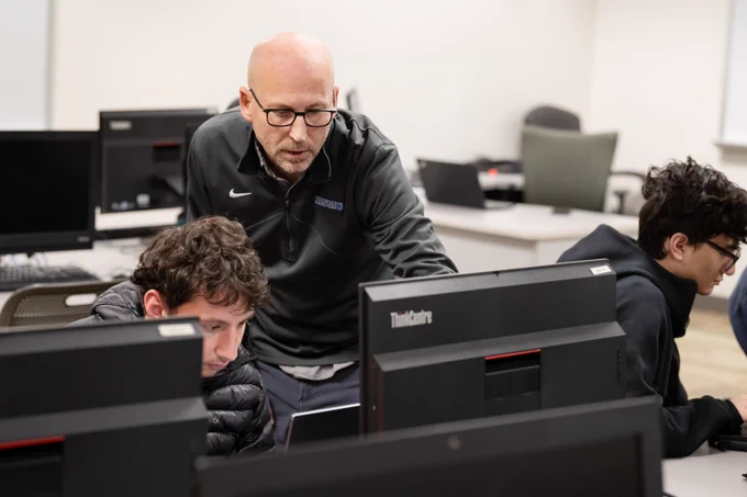 Faculty member working with a student.