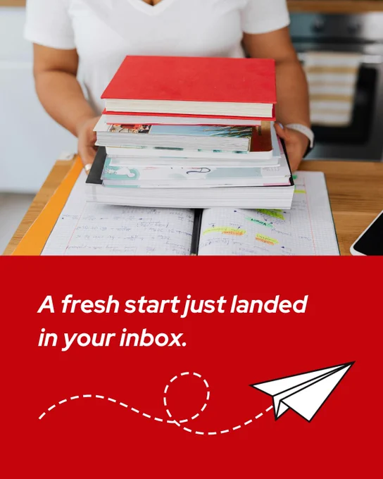 Woman wearing a white t-shirt holding a stack of books with a planner open on a wooden desk and text that reads: A fresh start just landed in your inbox. 