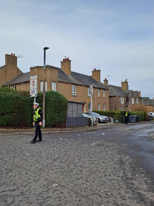 Two officers in full uniform patrolling the streets