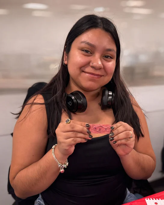 UB student holds up their stamp creation
