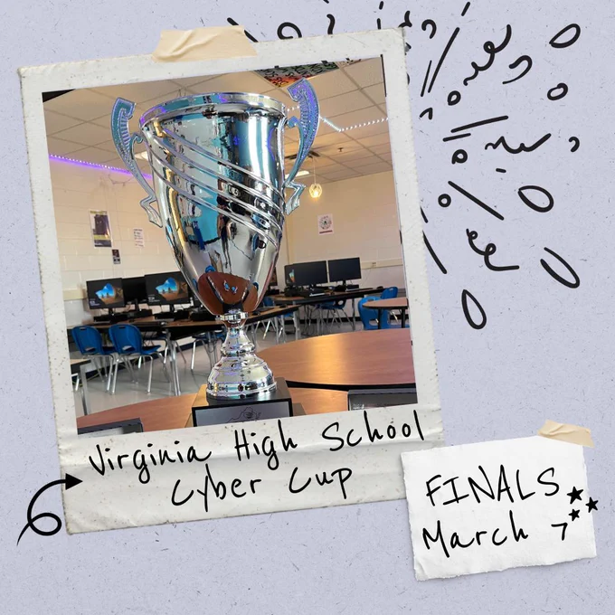 Silver trophy displayed in a classroom computer lab, framed with handwritten text reading “Virginia High School Cyber Cup” and “Finals March 7.”