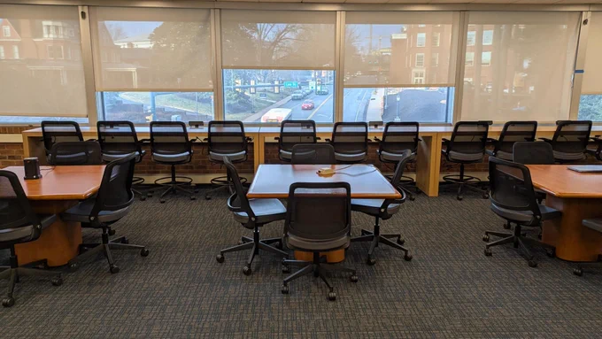 chairs, tables and desks near a window