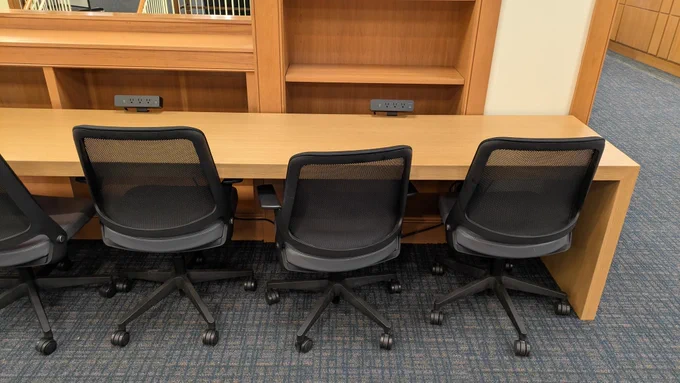 a long desk and chairs