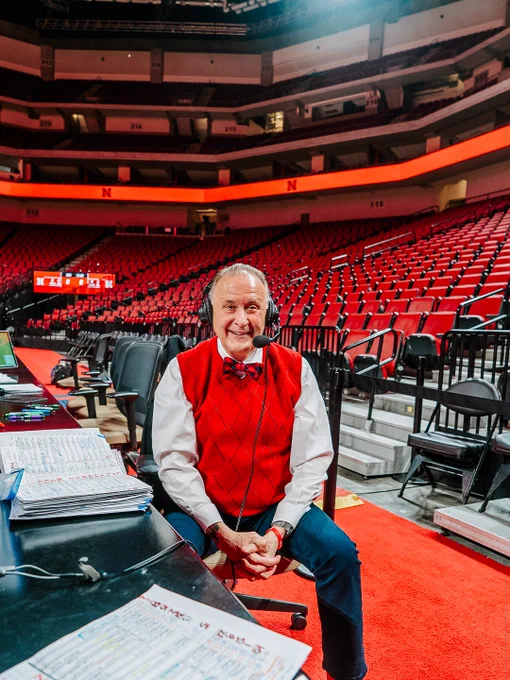 Kent smiles in his chair court-side at PBA with his headphones over his ears
